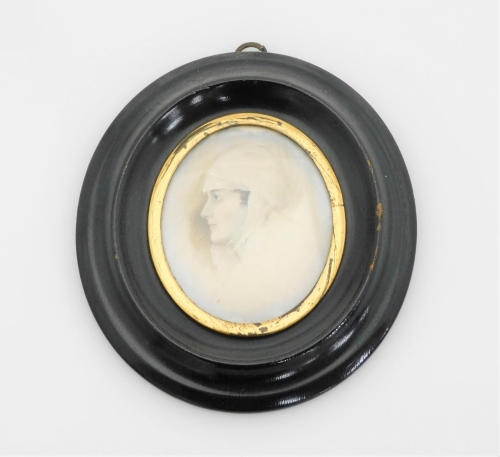 An early 19thC portrait miniature, depicting a maiden in headdress, painted on ivory, 5.5cm x 5cm, in a gilt surround, in a black oval frame, with numbering to paper back 130P, 12cm x 10cm.