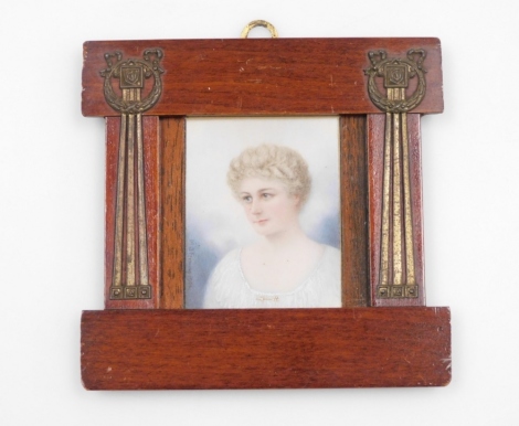 M.J. Fleming (early 20thC). Portrait miniature of a lady, with white gown and gold arrow brooch jewellery, signed and dated 1906, 6.5cm x 5.5cm, in a mahogany frame, with brass applied decoration, 13cm x 13cm.