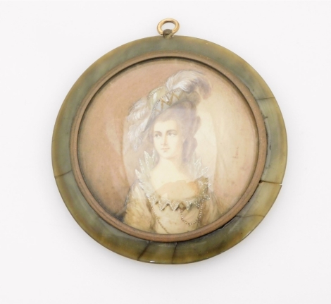 An early 19thC portrait miniature of a lady, elaborately dressed with evening gown, hat and jewellery, painted and signed Bone, 6cm diameter, in a brass surround, a green tortoiseshell case with applied floral decoration, 8cm wide. (AF)