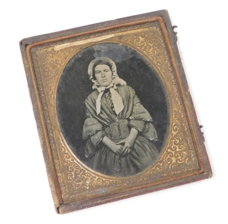 A late 19thC daguerreotype photograph miniature, depicting a lady, in a gold coloured frame, in a brown leather case, 8cm x 9xm. (AF)