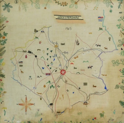 A late 20thC embroidered map of Leicestershire dated 1965, depicting various lions, animals and flowers, in a oak frame, 62.5cm x 62cm.