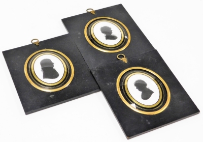 A pair of 19thC silhouettes, and another similar, each of oval form, facing sinister and dexter, comprising a gentleman and two ladies, in verre eglomise lined oval mounts and rectangular ebonised frames, with profile painter and jewellers labels hand wri