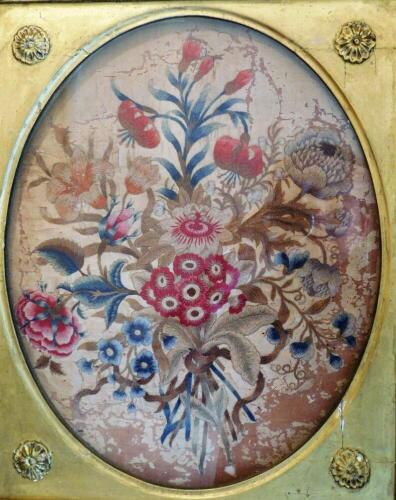 A George III needlework floral panel, 37cm x 30cm oval, (AF), gilt framed.