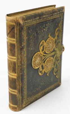 A late Victorian leather bound photograph album, with brass strap work, and a collection of portrait photographs.