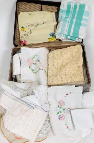 A group of linen and lace, to include doilies, tablecloths, napkins, some with floral knitting, a bright flower design tablecloth, etc. (enclosed in one trunk)