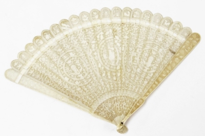 A 19thC Chinese ivory fan, with turned handle, pierced and decorated with raised flowers, each spoke with a blind fret of further flowers, 19cm wide.