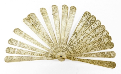 A 19thC Chinese ivory fan, with shaped pierced spokes decorated with figures, trees and buildings, with a shaped handle and pierced blind fret centre, 19cm high.