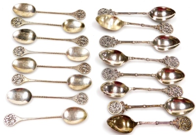 Sixteen teaspoons, the bowls presentation engraved, terminals with pierced monograms, silver and white metal, 9.22oz all in.