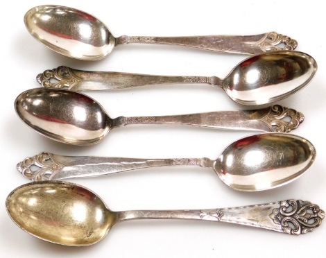 A group of five similar designed spoons, to include a set of four Norwegian silver spoons, each with foliate scroll design top, on reeded fluted stem, bearing the makers stamp NM white metal stamped 830S, with goblet and date letter N, 4oz, together with 