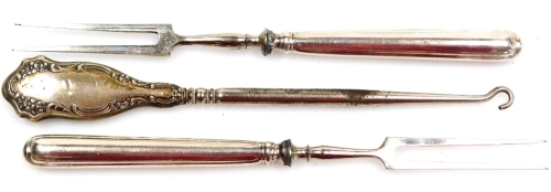 Two silver plated handled prongs, and a Victorian silver plate foliate scroll button hook. (3)