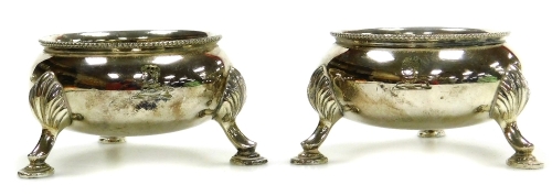 A pair of Victorian silver crested cauldron salts, by T. Bradbury & Son of Sheffield, each on three stepped feet, 8cm diameter, 7oz.