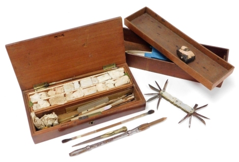 A 1930's mahogany cased artist box, complete with fitted sections set with various pigments and drawing implements, the box 23cm wide, a late 19thC mother of pearl handled penknife with various blades and shaped handle, a further 19thC mahogany box insert