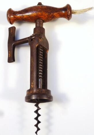 A 19thC Lund Hipkins patent corkscrew, with articulated and pinion operation, with shaped wooden handle set with brush, unmarked, 18cm high.