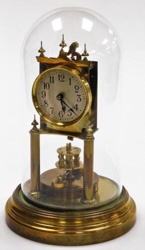 A brass anniversary clock, with two wind movement in a plastic dome, 31cm high.