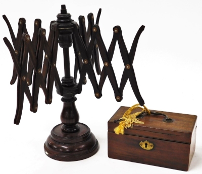 Two items of treen, to include a mahogany wool winder and a small oak storage box, with brass applied handles, the rack 35cm high, the box 18cm wide.