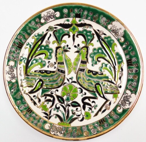 A Ibisulis Kerdarlik Rods collectors plate, the decoration depicting two birds, in green decoration with gilt surrounds, 24cm diameter, signed to reverse.