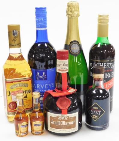 A group of alcohol, to include two miniature Martell Cognac bottles, a Marks and Spencer's port, a Rochester non alcoholic ginger drink, Harveys sherry cream, a Fortnum and Mason champagne root, a Grand Mariner liquor, etc. (a quantity)