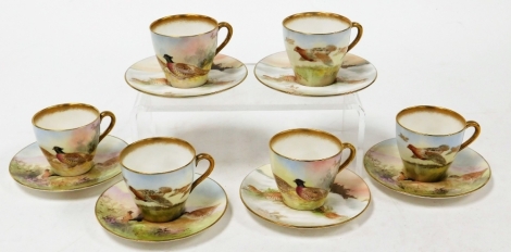 Six Royal Doulton porcelain cups and saucers, three depicting grouse and numbered BB3530 H4586, bearing signature M Betteley, and three further examples with pheasants and grouse in snowy landscapes, numbered BB3530 H4586, with same artist signature. (6)