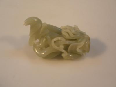 A Chinese jade finger citron in the form of Buddha's hand supporting a bird