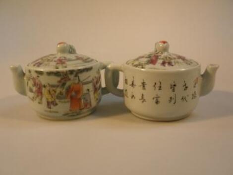 A pair of Chinese porcelain teapots decorated with figures in landscape