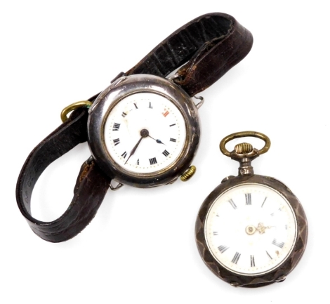 Two silver cased fob watches, to include a Continental fob watch, with white enamelled dial, with gilt tooled decoration, bezel wind, white metal unmarked with foliate scrolling and shield to back bearing the initials AM, together with a late 19thC wristw