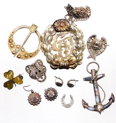 A group of silver and other jewellery, comprising a silver and agate set three leaf clover brooch, a white metal anchor and agate set brooch unmarked, a silver horseshoe stick pin top, a silver scarf pin, a pair of marcasite earrings, a pair of silver fil