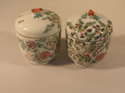 A pair of Chinese jars and covers decorated with Peonies and bamboo