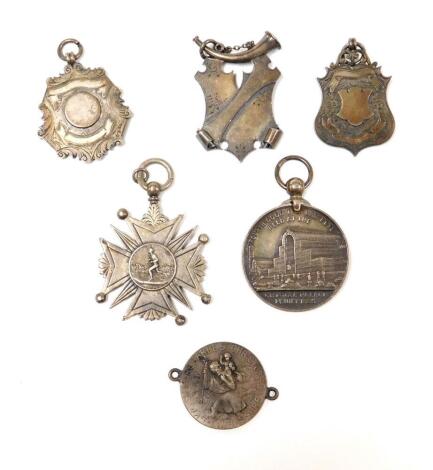 Various silver and other fobs and medals, comprising a Crystal Palace 1885 medallion, a silver shield fob, a silver crest and horn pendant, a silver shield fob with circular centre, a running badge and a steel Religious part bracelet. (6)