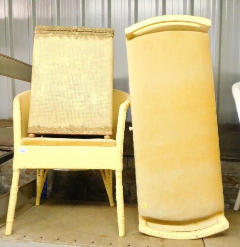 A group of Lloyd Loom style furnishings, each painted in yellow comprising a velvet cushioned blanket box, 90cm wide, and a commode chair, together with a gilt coloured laundry basket. (3)