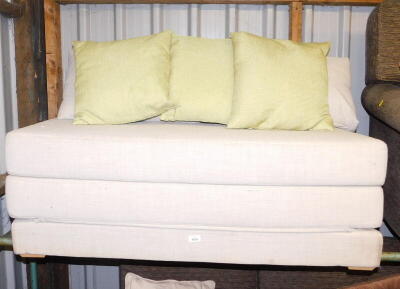 A grey fabric fold out sofa bed.