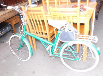 A 20 BSA bicycle, in a green livery, with a white leather seat, and a Pletsher of Switzerland storage rack. (2)