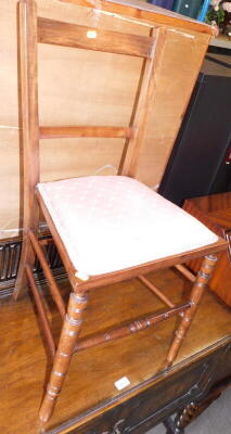 An Edwardian mahogany bedroom chair, with pink upholstered seat, 83cm high, 39cm wide.