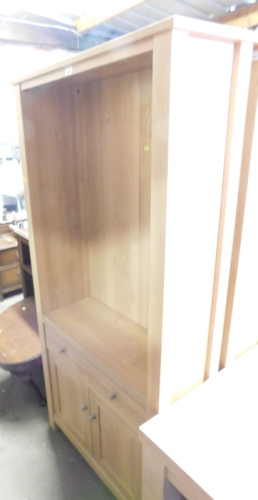 A modern beech effect wall unit, with book shelf top above single drawer with chrome handles and a two door cupboard base, 185cm high, 84cm wide, 35cm deep.