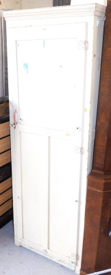 A cream painted pine kitchen cupboard, opening to reveal four shelves, with a red plastic handle, 170cm high, 60cm wide, 37cm deep.