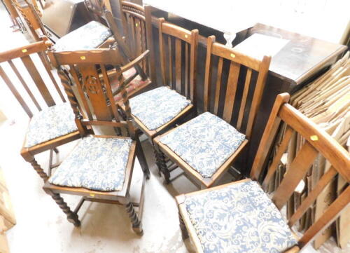 A group of oak dining chairs, comprising a set of four dining chairs with barleytwist legs, two matched chairs with barleytwist column supports, and a later carver chair, each florally upholstered. (7)