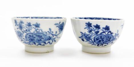 Two Chinese 18thC blue and white porcelain tea bowls, decorated with sprigs of flowers, 7.5cm diameter.