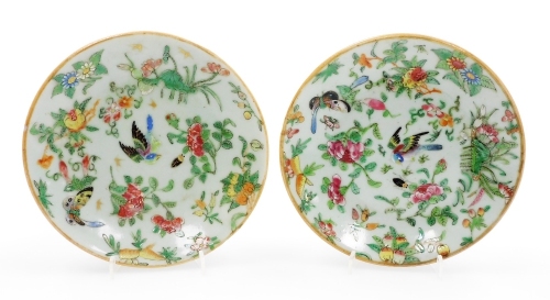 Two late 19thC Cantonese porcelain plates, each polychrome decorated with flowers, gilding to surround, underglaze blue marks to underside, 18cm diameter.