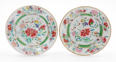 A pair of 18th/19thC Chinese porcelain plates, decorated in enamels with peonies, flowers and leaves, gilt borders, 22.5cm diameter.