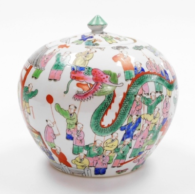 A Chinese porcelain jar and cover, decorated in coloured enamels with a dragon festival, red four character mark of Tongzhi (1862-1874) and possibly of the period, 21cm high. - 2