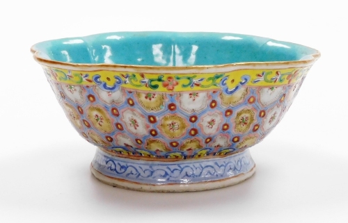 A 20thC Chinese porcelain bowl, with undulating rim, decorated in enamels with diaper designs within scrolling borders, turquoise ground to base and interior, marked to underside 'China' and six character Qianlong mark, 7cm high, 17cm wide.