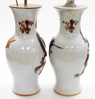 A pair of Chinese porcelain crackle glaze table lamps, each raised with a gilt dragon design, converted, with stamps to base, 46cm high. - 4