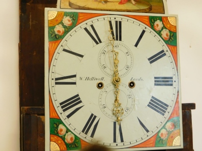 W.Helliwell, Leeds. A longcase clock, with an arched painted dial, decorated with a biblical tableau, above floral spandrels, with an eight day four pillar movement, in broad figured mahogany and crossbanded case, 249cm high overall. - 2