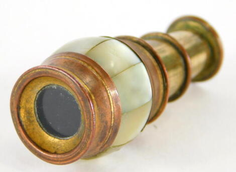 A 19thC miniature brass and copper two draw spy glass or monocular telescope, with a band of mother of pearl, previously with pendant mounting loop, 4.5cm long extended.