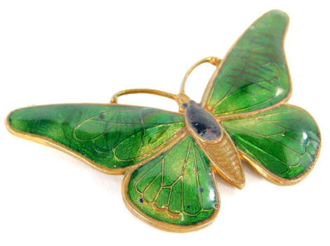 A continental Art Deco brass and enamel butterfly brooch, with green wings, unmarked, 6cm wide.