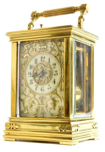 A late 19thC/early 20thC French carriage clock, the cream coloured dial applied with Gothic motifs, the case with bevelled glass and simulated strap work, the movement with repeat mechanism, (AF), 20cm.
