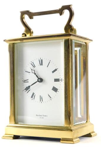 A brass carriage clock by Shortland Bowen, with bevelled glass sides, the movement stamped Made In England, 15.5cm high overall.