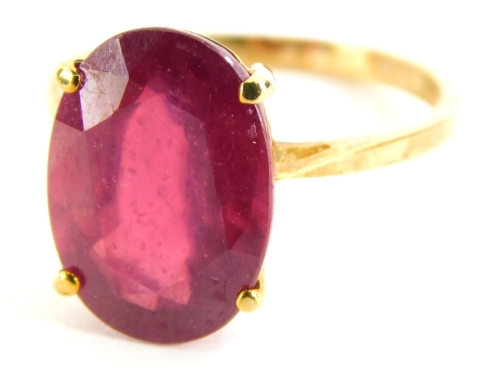 A 9ct gold dress ring, set with oval cut garnet, in a basket setting, on a plain band, yellow metal stamped 375, ring size O, 3.1g all in, boxed.