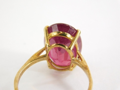 A 9ct gold dress ring, set with oval cut garnet, in a basket setting, on a plain band, yellow metal stamped 375, ring size O, 3.1g all in, boxed. - 2