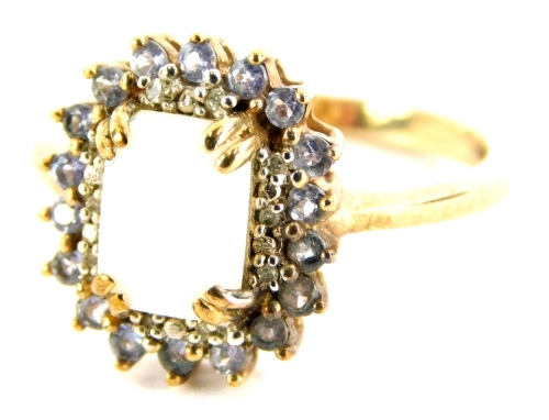 An opal and tanzanite set dress ring, with central rectangular cut opal, in claw setting, surrounded by cz stones and a further halo of tanzanite, in a yellow metal setting, stamped 9k, ring size P, 2.6g all in, boxed.