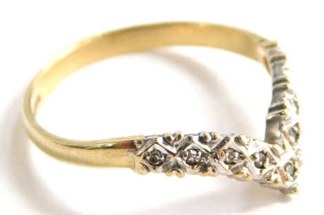 A 9ct gold wishbone ring, illusion set with tiny diamonds, in a white metal setting, on a yellow metal band, hallmarked 9ct, ring size M, 1.4g all in, boxed.